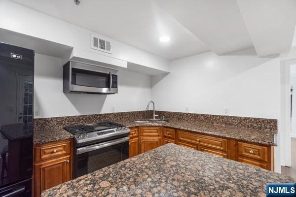 2608 Kennedy Blvd Unit 1, Union City, NJ 07087 - kitchen featuring stainless steel appliances, brown cabinets, dark stone countertops, and recessed lighting