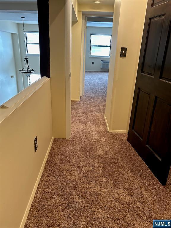 111 Mulberry St Unit 1418, Newark, NJ 07102 - hall featuring carpet, plenty of natural light, and a wall mounted AC