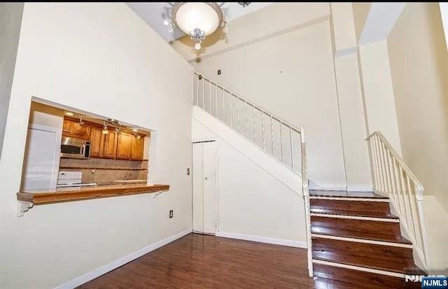 111 Mulberry St Unit 1418, Newark, NJ 07102 - staircase featuring a high ceiling and wood finished floors
