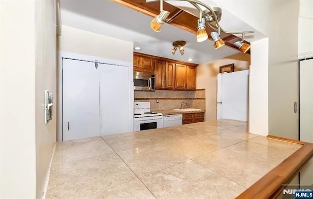 111 Mulberry St Unit 1418, Newark, NJ 07102 - kitchen with white appliances, brown cabinets, decorative backsplash, recessed lighting, and tile patterned flooring