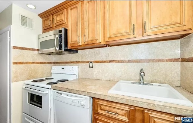 111 Mulberry St Unit 1418, Newark, NJ 07102 - kitchen featuring white appliances, tile walls, and decorative backsplash