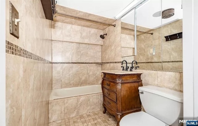 111 Mulberry St Unit 1418, Newark, NJ 07102 - full bathroom featuring tile walls, tiled shower / bath, vanity, and tile patterned floors