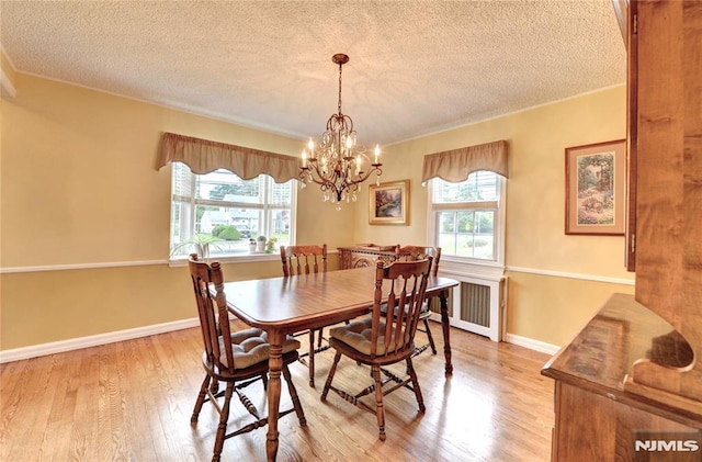 306 Boulevard, Pequannock Township, NJ 07444 - dining space with a textured ceiling, light wood finished floors, a chandelier, crown molding, and radiator