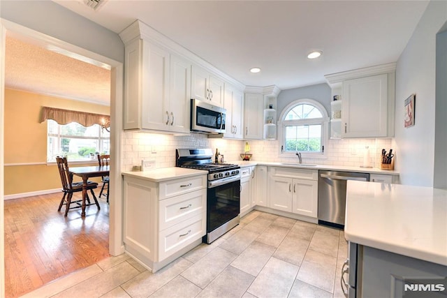 306 Boulevard, Pequannock Township, NJ 07444 - kitchen with stainless steel appliances, open shelves, light countertops, white cabinets, and recessed lighting