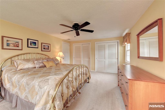 306 Boulevard, Pequannock Township, NJ 07444 - bedroom with multiple closets, light carpet, a ceiling fan, and a textured ceiling