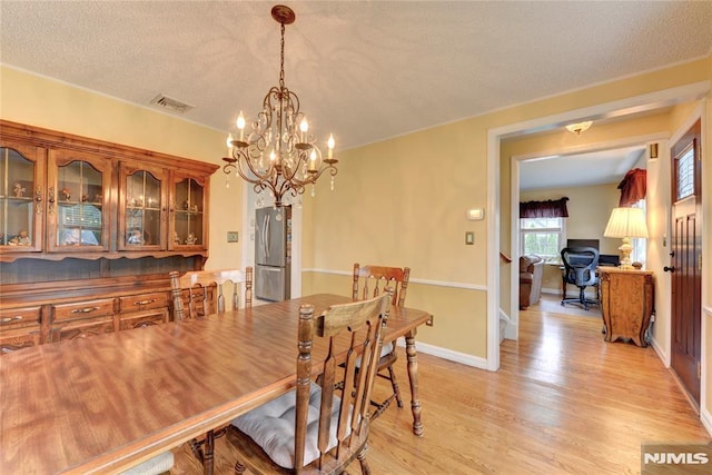 306 Boulevard, Pequannock Township, NJ 07444 - dining space featuring a chandelier, light wood finished floors, a textured ceiling, and an office area