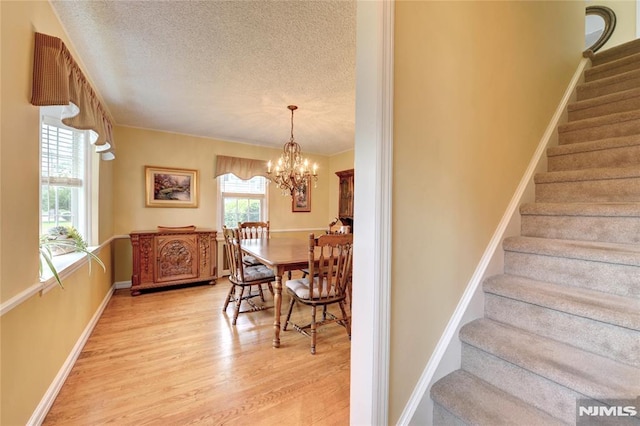 306 Boulevard, Pequannock Township, NJ 07444 - stairs featuring wood finished floors, a textured ceiling, and a chandelier