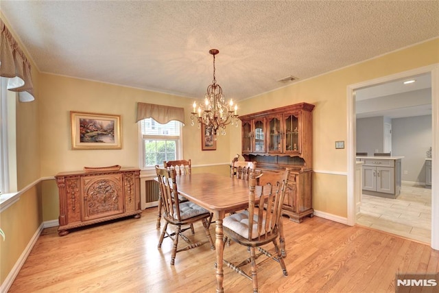 306 Boulevard, Pequannock Township, NJ 07444 - dining space with a chandelier, a textured ceiling, and light wood finished floors