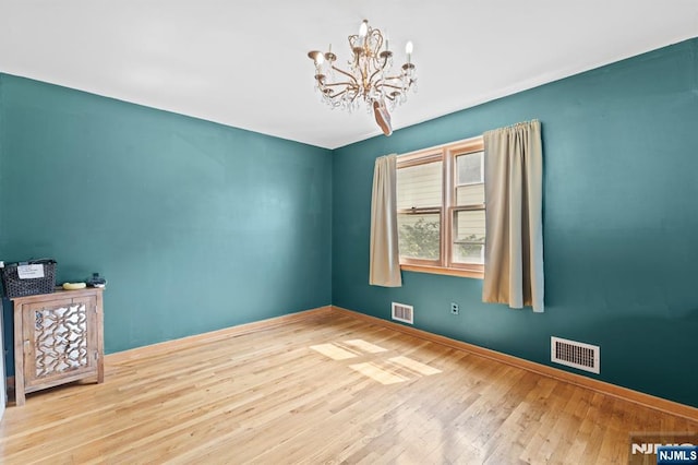132 17th St, Prospect Park, NJ 07508 - empty room with wood-type flooring and a chandelier
