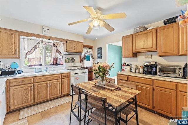 132 17th St, Prospect Park, NJ 07508 - kitchen with white range with gas stovetop, light countertops, a ceiling fan, and light tile patterned floors