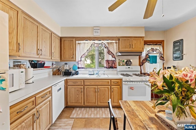 132 17th St, Prospect Park, NJ 07508 - kitchen with white appliances, light countertops, a ceiling fan, light tile patterned floors, and range hood
