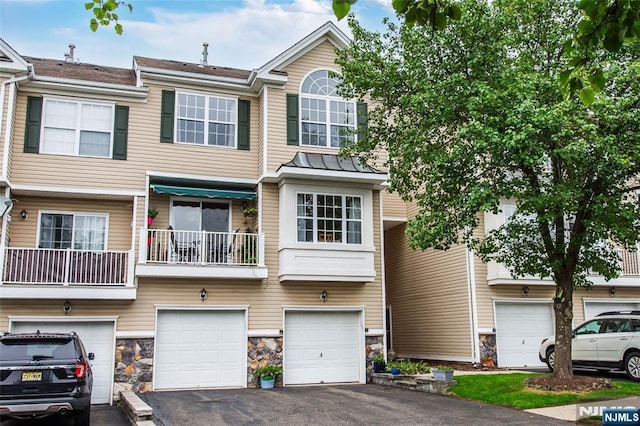 143 Summit Rdg, Pompton Lakes, NJ 07442 - view of property with driveway, an attached garage, and stone siding