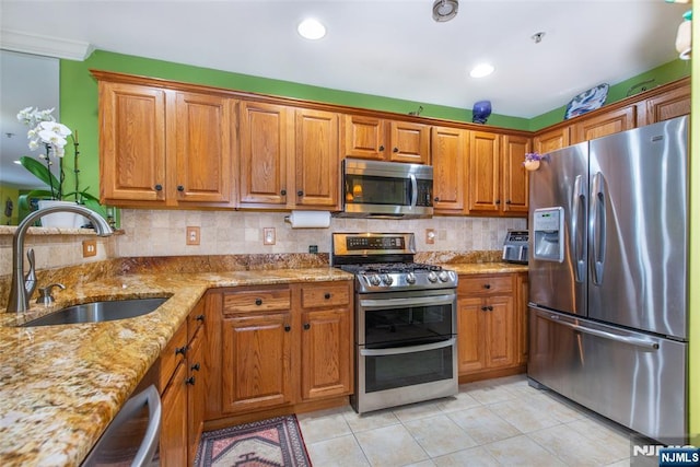 143 Summit Rdg, Pompton Lakes, NJ 07442 - kitchen featuring appliances with stainless steel finishes, light tile patterned floors, brown cabinets, and light stone countertops