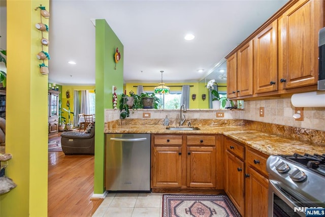 143 Summit Rdg, Pompton Lakes, NJ 07442 - kitchen featuring appliances with stainless steel finishes, brown cabinets, light stone counters, tasteful backsplash, and recessed lighting