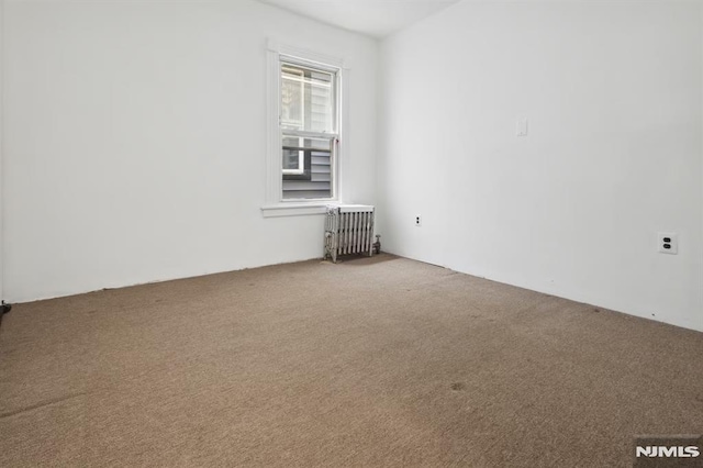 223 N 6th St, Newark, NJ 07107 - carpeted spare room featuring radiator