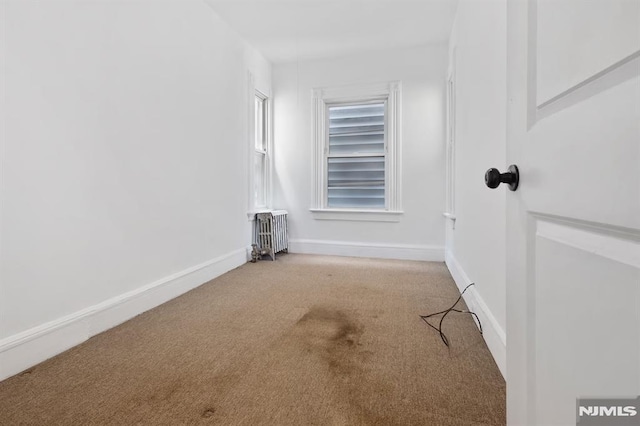 223 N 6th St, Newark, NJ 07107 - spare room with radiator heating unit and carpet