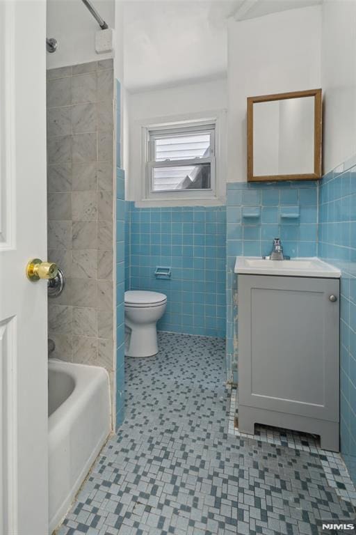 223 N 6th St, Newark, NJ 07107 - bathroom with tile walls, vanity, shower / tub combination, and wainscoting