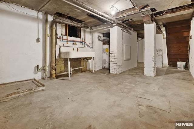 223 N 6th St, Newark, NJ 07107 - unfinished basement featuring water heater and a sink