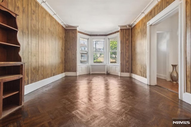 223 N 6th St, Newark, NJ 07107 - unfurnished living room with radiator heating unit, wooden walls, and crown molding