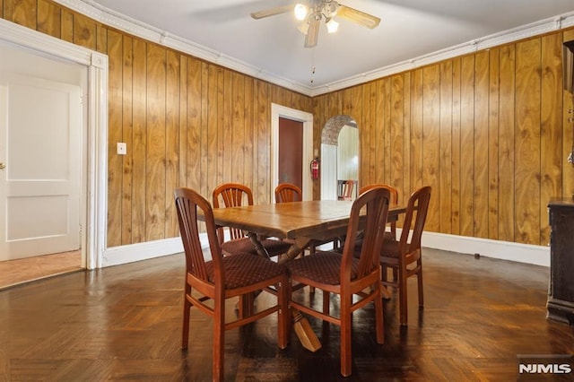 223 N 6th St, Newark, NJ 07107 - dining room with ceiling fan, arched walkways, wooden walls, and ornamental molding