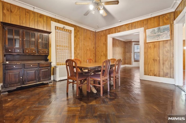 223 N 6th St, Newark, NJ 07107 - dining space featuring ceiling fan, ornamental molding, wooden walls, and radiator
