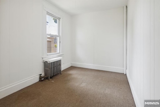 223 N 6th St, Newark, NJ 07107 - spare room with radiator and carpet floors