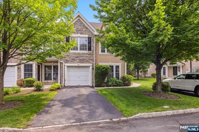 66 Spruce Ln, North Haledon, NJ 07508 - townhome / multi-family property featuring stone siding, a front yard, asphalt driveway, an attached garage, and stucco siding