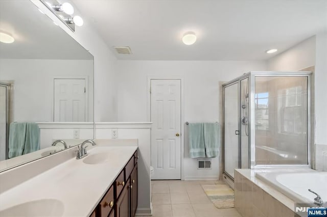 66 Spruce Ln, North Haledon, NJ 07508 - full bath featuring double vanity, tile patterned flooring, a bath, and a stall shower