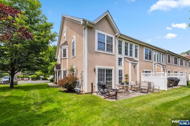 66 Spruce Ln, North Haledon, NJ 07508 - back of property featuring stucco siding and a patio