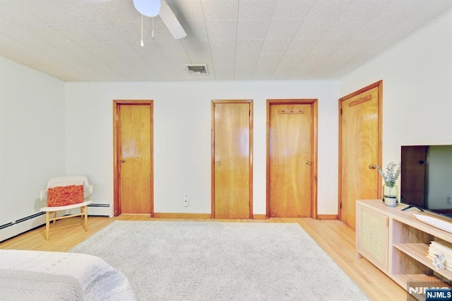 76 Central Ln, Secaucus, NJ 07094 - bedroom featuring light wood-style flooring, multiple closets, a baseboard radiator, and ceiling fan