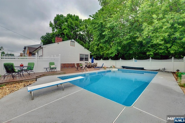 76 Central Ln, Secaucus, NJ 07094 - view of swimming pool with a diving board, a fenced backyard, a deck, and a patio