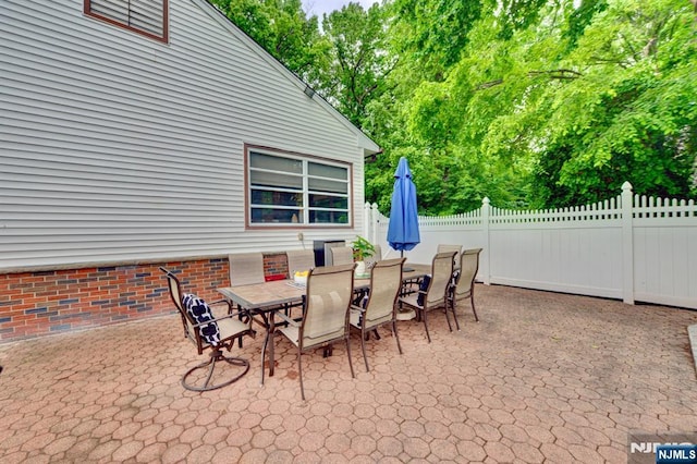 76 Central Ln, Secaucus, NJ 07094 - view of patio with outdoor dining area and view of wooded area
