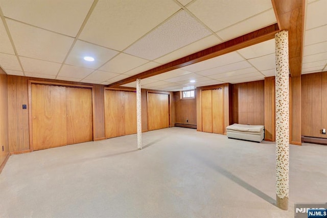 76 Central Ln, Secaucus, NJ 07094 - basement with a paneled ceiling, a baseboard radiator, wood walls, and carpet flooring