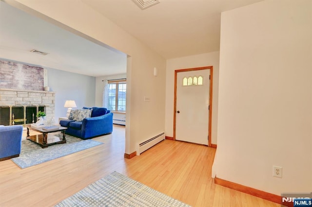 76 Central Ln, Secaucus, NJ 07094 - entryway with a baseboard radiator, light wood finished floors, and a fireplace