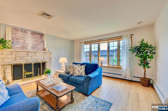 76 Central Ln, Secaucus, NJ 07094 - living room featuring wood finished floors, a baseboard radiator, and a stone fireplace