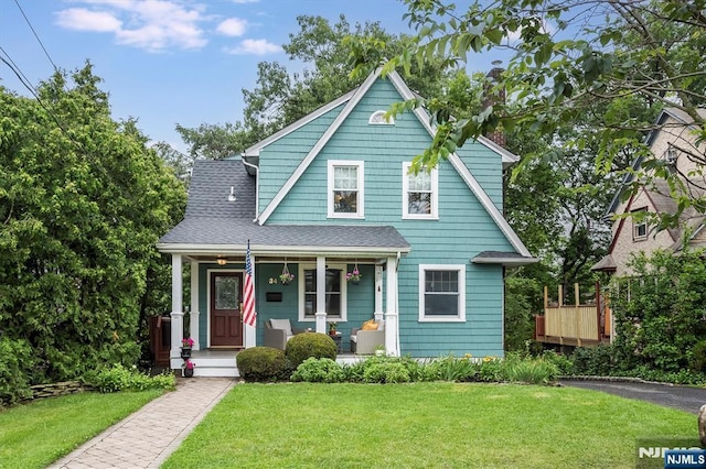34 Harding Rd, Glen Rock, NJ 07452 - view of front of house featuring covered porch, a front lawn, and a shingled roof