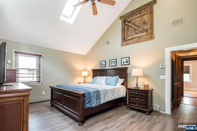 34 Harding Rd, Glen Rock, NJ 07452 - bedroom with a baseboard heating unit, light wood-style floors, high vaulted ceiling, a skylight, and a ceiling fan