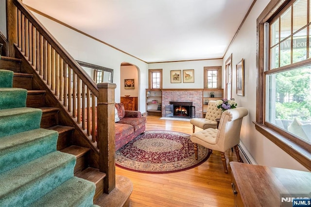 34 Harding Rd, Glen Rock, NJ 07452 - living area with healthy amount of natural light, wood-type flooring, stairway, crown molding, and a brick fireplace