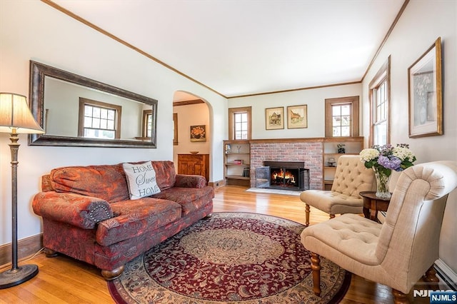 34 Harding Rd, Glen Rock, NJ 07452 - living room featuring wood finished floors, crown molding, arched walkways, and a fireplace