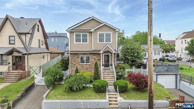 695 Midland Ave, Garfield, NJ 07026 - view of front of property with a gate, a residential view, driveway, and stone siding