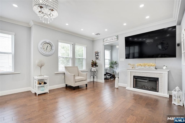 695 Midland Ave, Garfield, NJ 07026 - sitting room with a chandelier, ornamental molding, wood finished floors, recessed lighting, and a stone fireplace