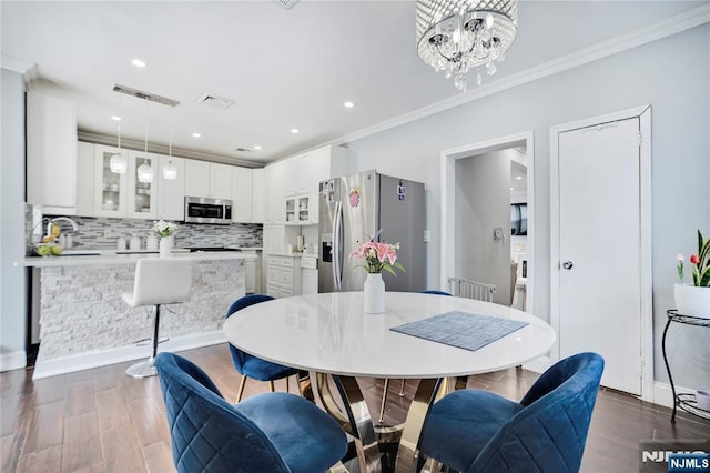 695 Midland Ave, Garfield, NJ 07026 - dining room with ornamental molding, dark wood-style flooring, a chandelier, and recessed lighting