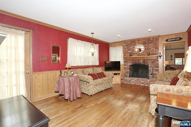 279 Rock Ave, Park Ridge, NJ 07656 - living room with wood finished floors, a fireplace, wood walls, crown molding, and a wainscoted wall