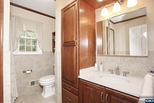 279 Rock Ave, Park Ridge, NJ 07656 - bathroom with tile walls, vanity, crown molding, tile patterned floors, and a wainscoted wall