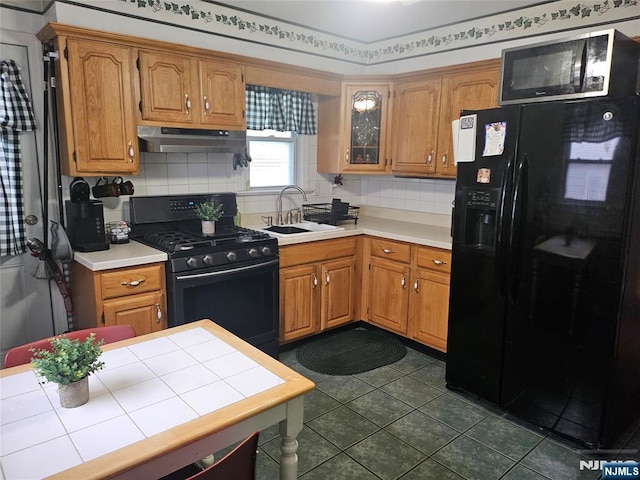100 Grove St, Waldwick, NJ 07463 - kitchen with under cabinet range hood, black appliances, backsplash, and dark tile patterned floors
