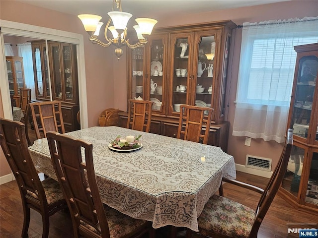 100 Grove St, Waldwick, NJ 07463 - dining room featuring a chandelier and dark wood-style flooring