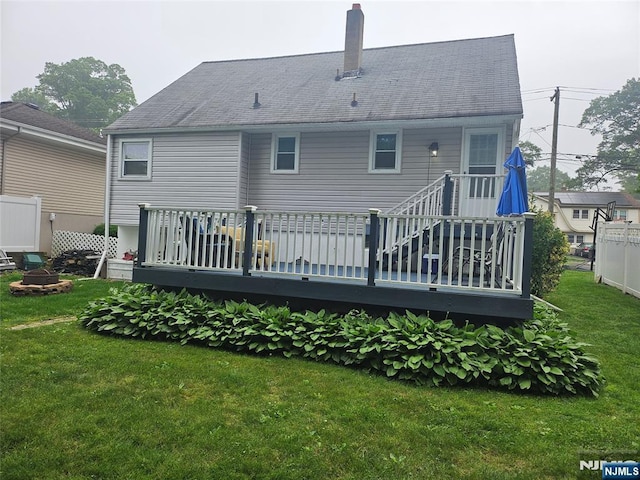 100 Grove St, Waldwick, NJ 07463 - rear view of property with a chimney, a lawn, and a wooden deck