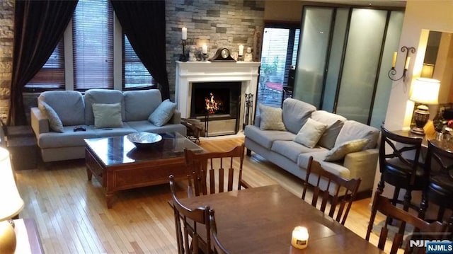 705 Mainsail Ln, Secaucus, NJ 07094 - living room with wood-type flooring and a lit fireplace