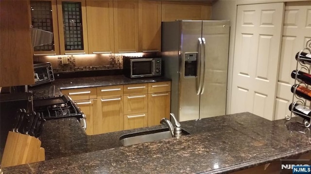 705 Mainsail Ln, Secaucus, NJ 07094 - kitchen with appliances with stainless steel finishes, dark stone counters, and glass insert cabinets