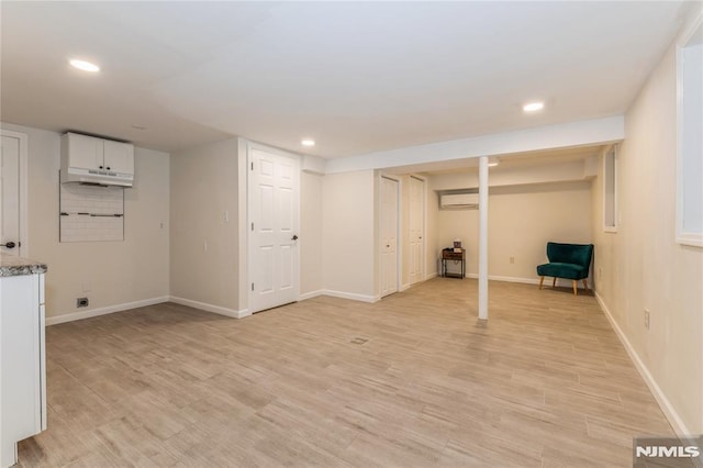 63 E Midland Ave, Kearny, NJ 07032 - finished basement featuring an AC wall unit, recessed lighting, and light wood finished floors